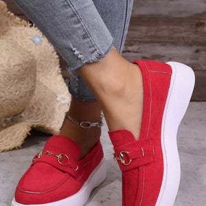 Red loafers with gold horse-bit detail and white platform sole.