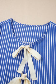 Blue striped blouse with tie-front detail and puff sleeves.