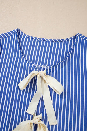 Blue striped blouse with tie-front detail and puff sleeves.