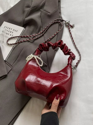 Burgundy ruched mini crossbody bag with pearl pendant and chain strap