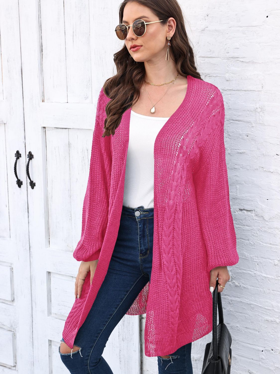 Cable knit cocoon cardigan in Deep Rose acrylic with open front and long sleeves.