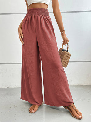 Rust textured palazzo lounge trousers with smocked waist and wide legs.