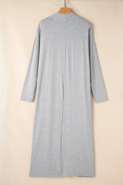Gray duster with mock neck and long sleeves, open front, midi length.