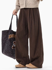 Men's brown pleated wide leg trousers with a relaxed fit