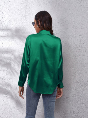 Green satin collared button-down shirt with long sleeves and a curved hem.
