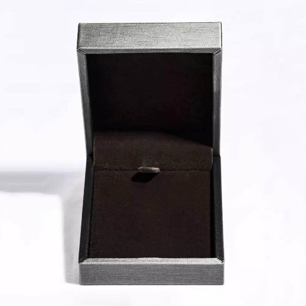 Open jewelry box with dark velvet lining and silver trim.