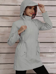 Light gray drawstring trench coat with plaid lining and hood.