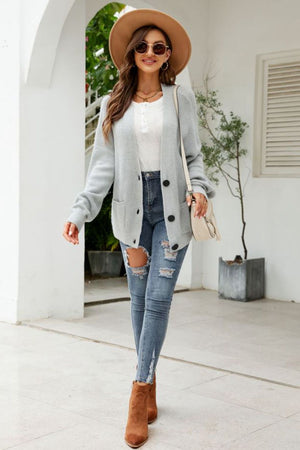 Light gray textured knit cardigan with oversized pockets and button front.
