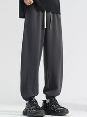 Men's dark gray loose fit sweatpants with drawstring and cuffed ankles