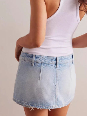 Light blue denim mini skort with button closure and frayed hem.