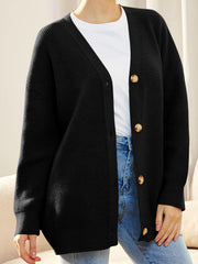 Black ribbed knit cardigan with balloon sleeves and button front, styled with a white tee and jeans.