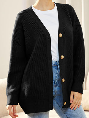 Black ribbed knit cardigan with balloon sleeves and button front, styled with a white tee and jeans.