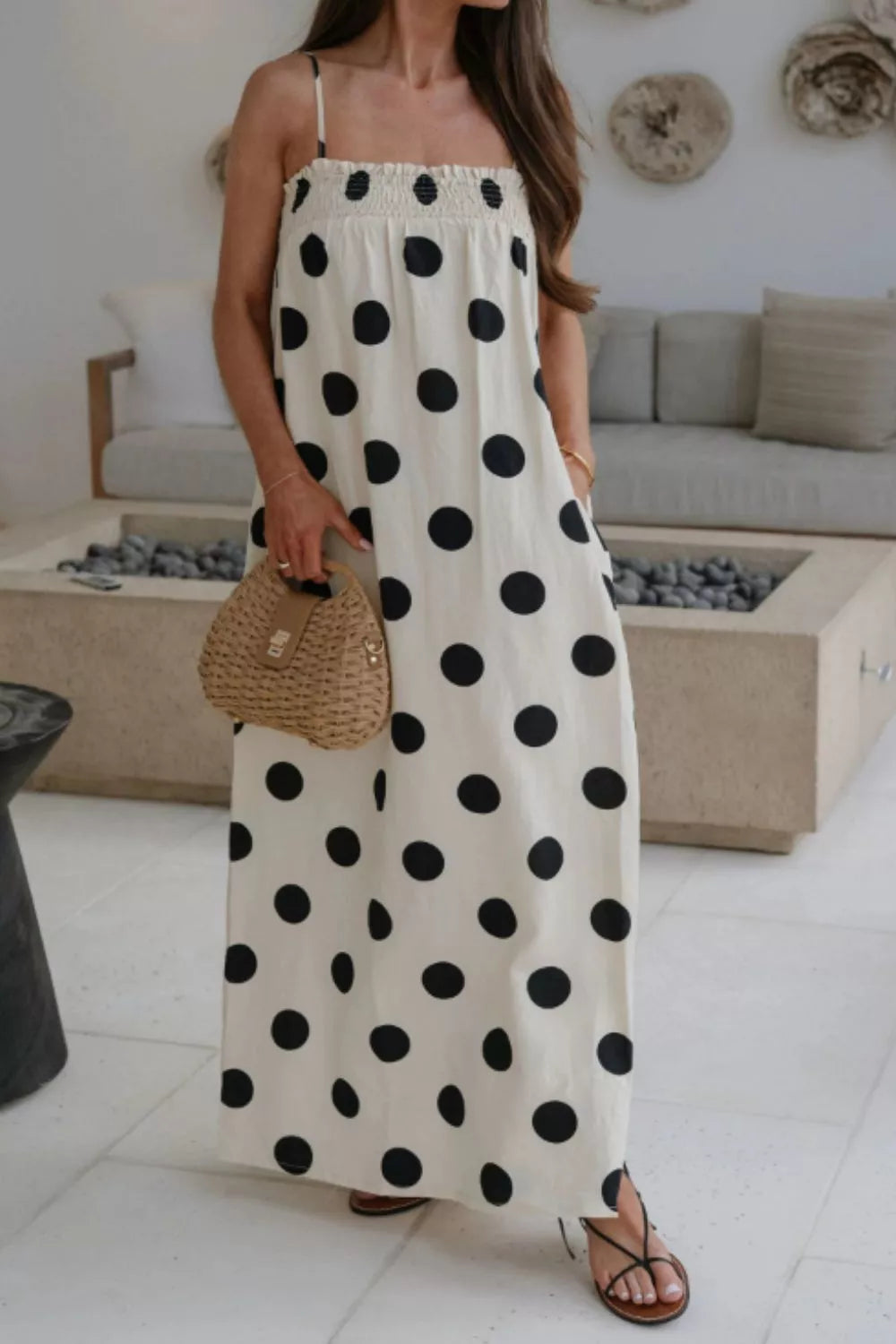 Cream polka dot maxi dress with smocked bodice and pockets.