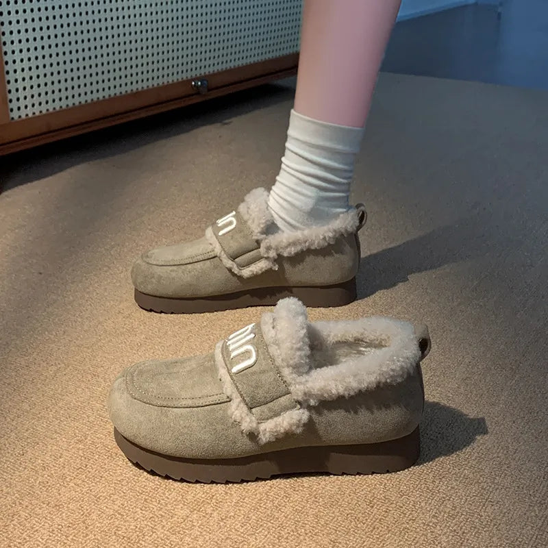 Logo strap shearling loafers in sage with fluffy trim and white socks.
