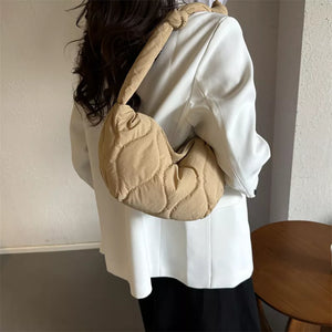 Khakis puffy quilted crossbody bag with knotted strap and abstract pattern.