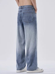 Relaxed fit men's sweatpants in light blue with vintage wash and gradient effect.