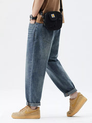 Men's blue washed stretch denim jeans with cuffed hems.