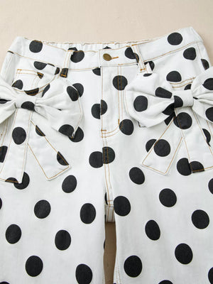 White polka dot denim jeans with large bow details on the pockets.