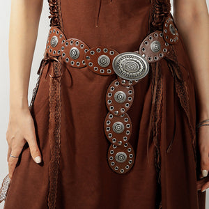 Western-inspired brown leather belt with eyelet and oval details and antique silver buckle.