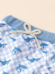 Baby blue checkered shark print shorts with drawstring and blue ribbed waistband.