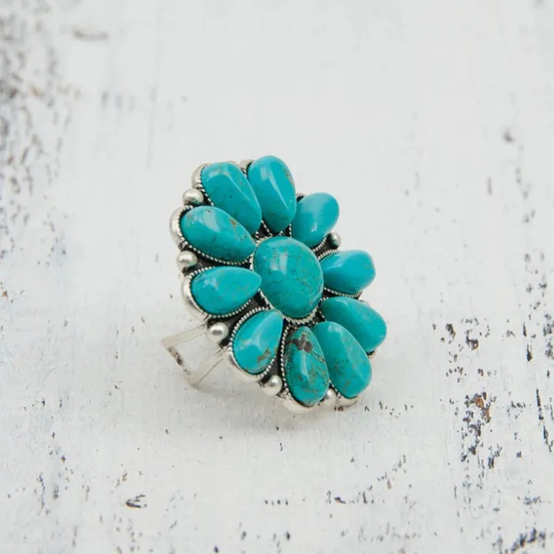 Turquoise blossom statement ring with artificial turquoise stones and silver alloy band.