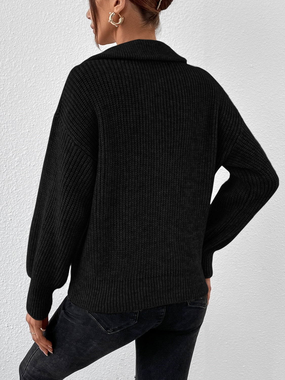 Black ribbed collar zip-up knit sweater with balloon sleeves.