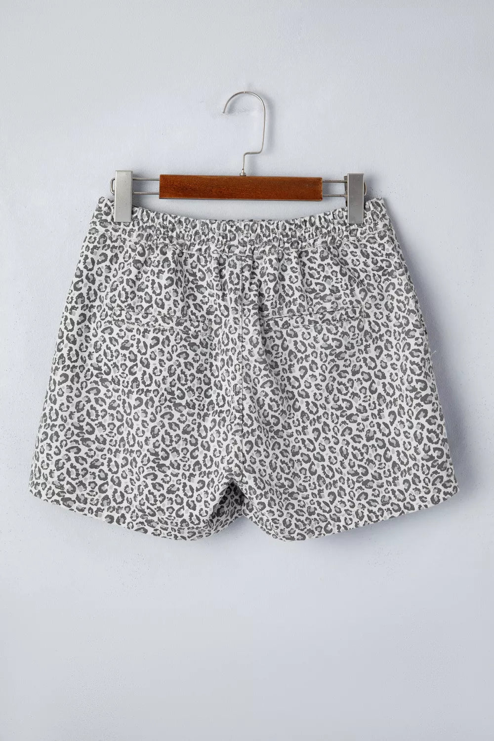 Denim shorts with leopard print, elastic waist, and pockets.