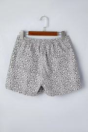 Denim shorts with leopard print, elastic waist, and pockets.