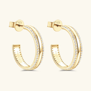 Gold pavé moissanite C-hoop earrings in sterling silver with diamond accents.
