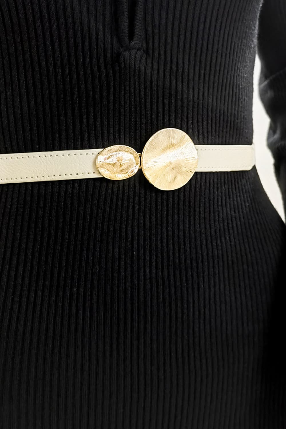Ivory elastic waist belt with gold disc detail.