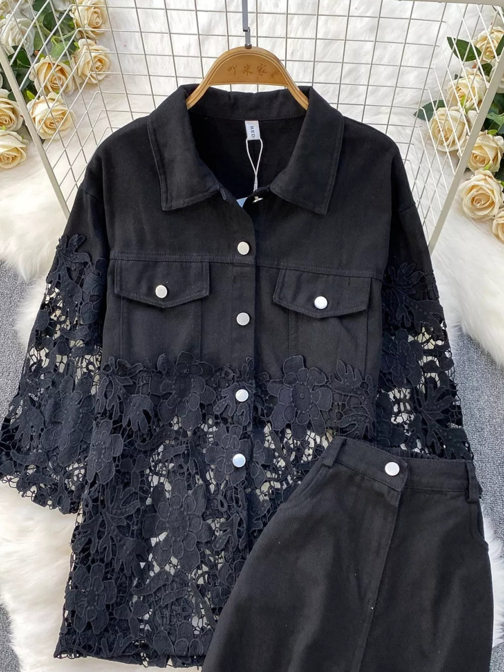 Black lace-embellished two-piece set with button-up collared jacket and matching bottoms.