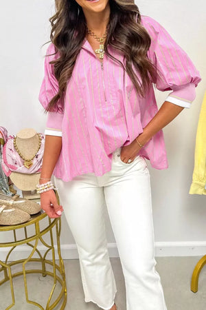 Pink striped half-zip polo shirt with puff sleeves and ribbed cuffs.