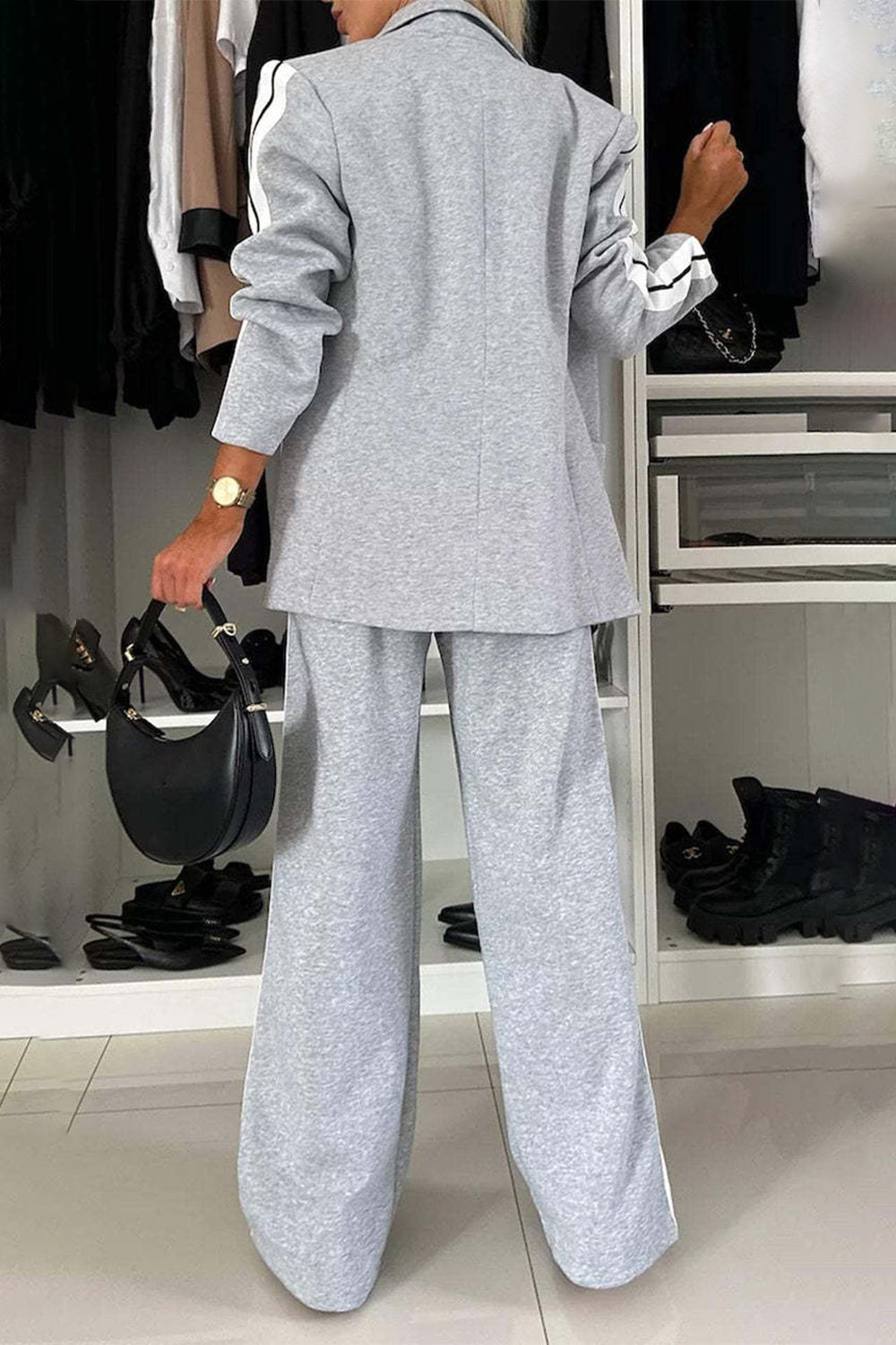 Light gray track stripe blazer and wide leg trouser set with black stripe detail on sleeves and pant legs.