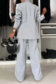 Light gray track stripe blazer and wide leg trouser set with black stripe detail on sleeves and pant legs.