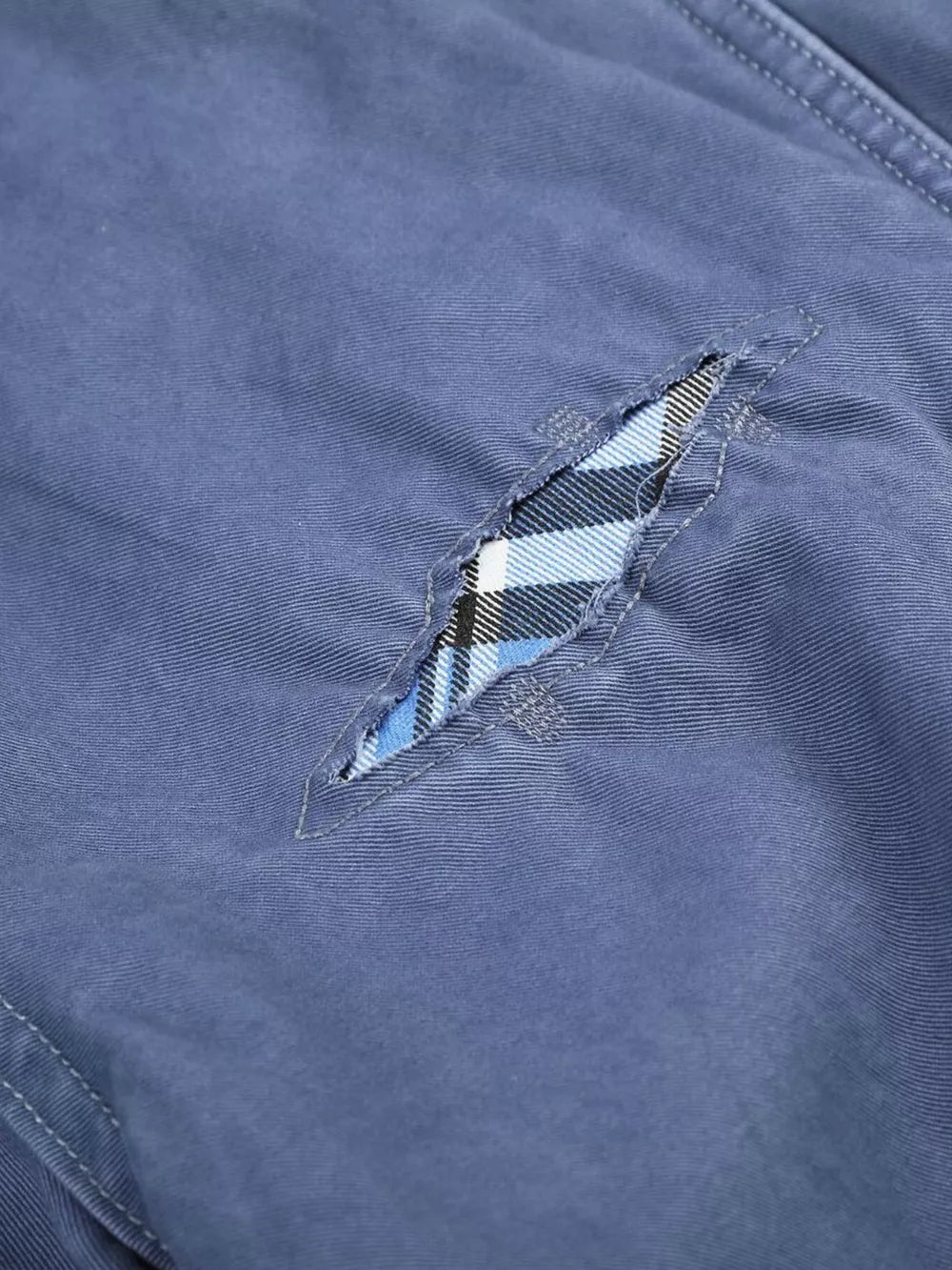 Blue maternity cargo capris with distressed detailing and plaid underlay.