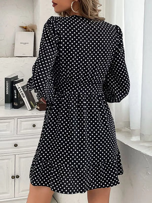 Black polka dot mini dress with balloon sleeves and ruffled hem.