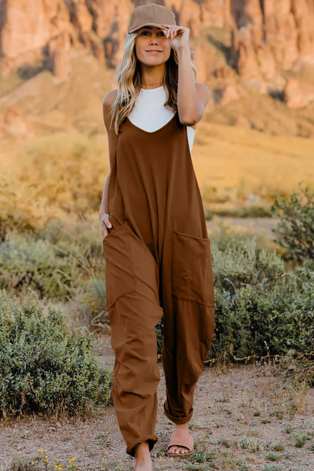 Coffee brown cotton V-neck wide-leg jumpsuit with pockets and a relaxed fit.