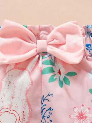 Pink baby outfit with bunny and floral print, featuring a large pink bow detail.