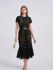 Black floral lace mermaid dress with short sleeves, pearl neckline, and jeweled bow belt.
