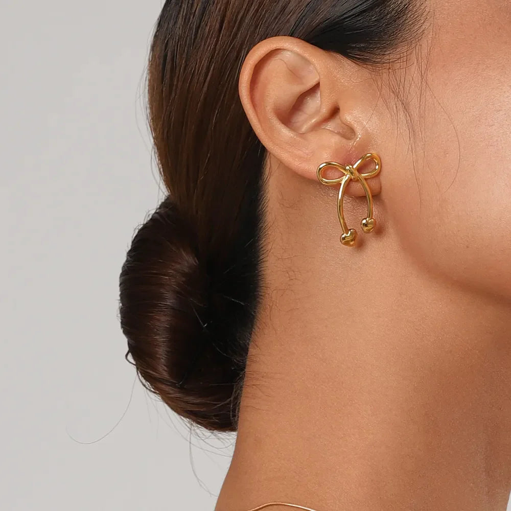 Gold bow drop earrings with heart tips