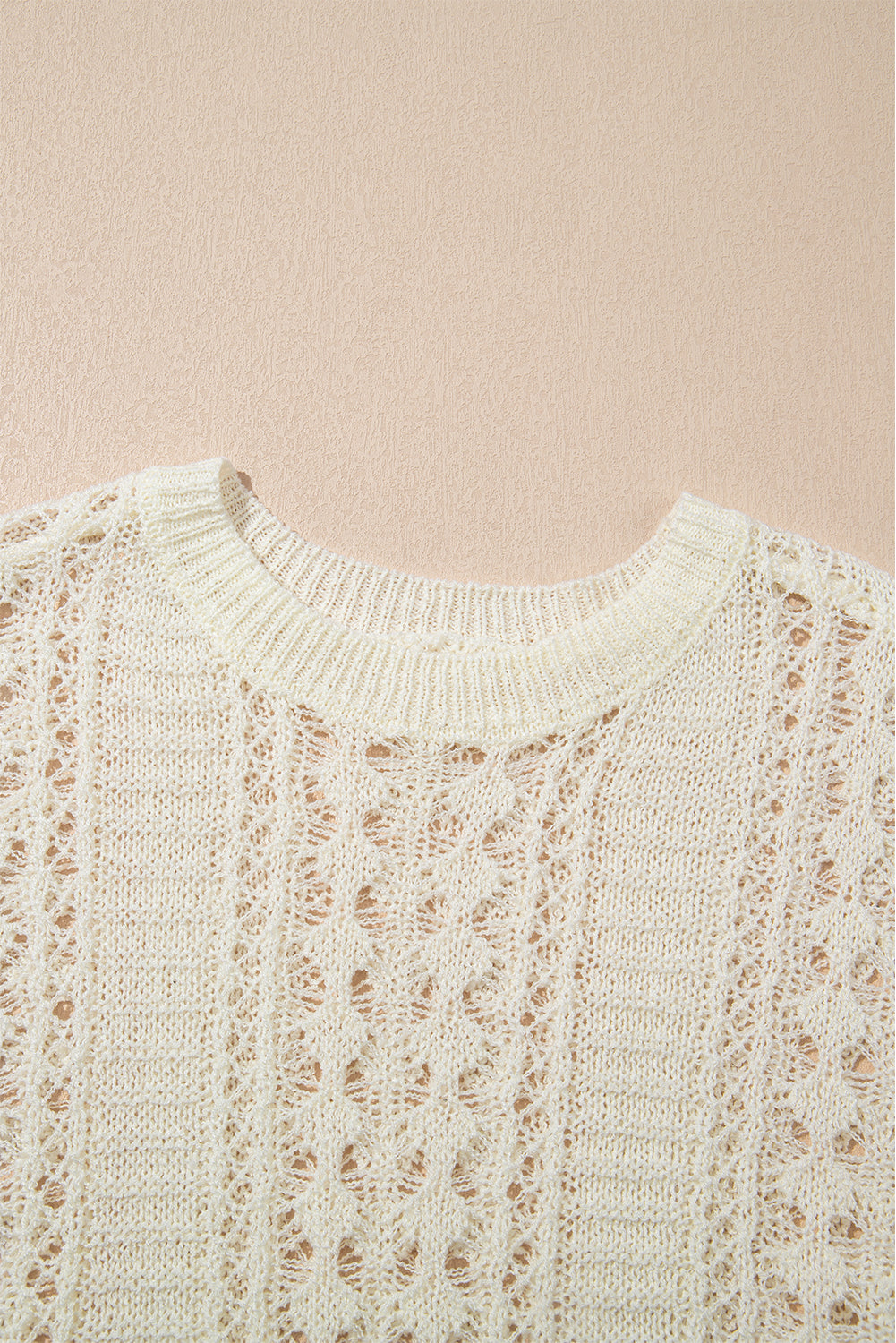 Beige openwork knit beach cover-up with crew neck and intricate diamond pattern.