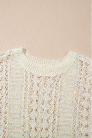 Beige openwork knit beach cover-up with crew neck and intricate diamond pattern.