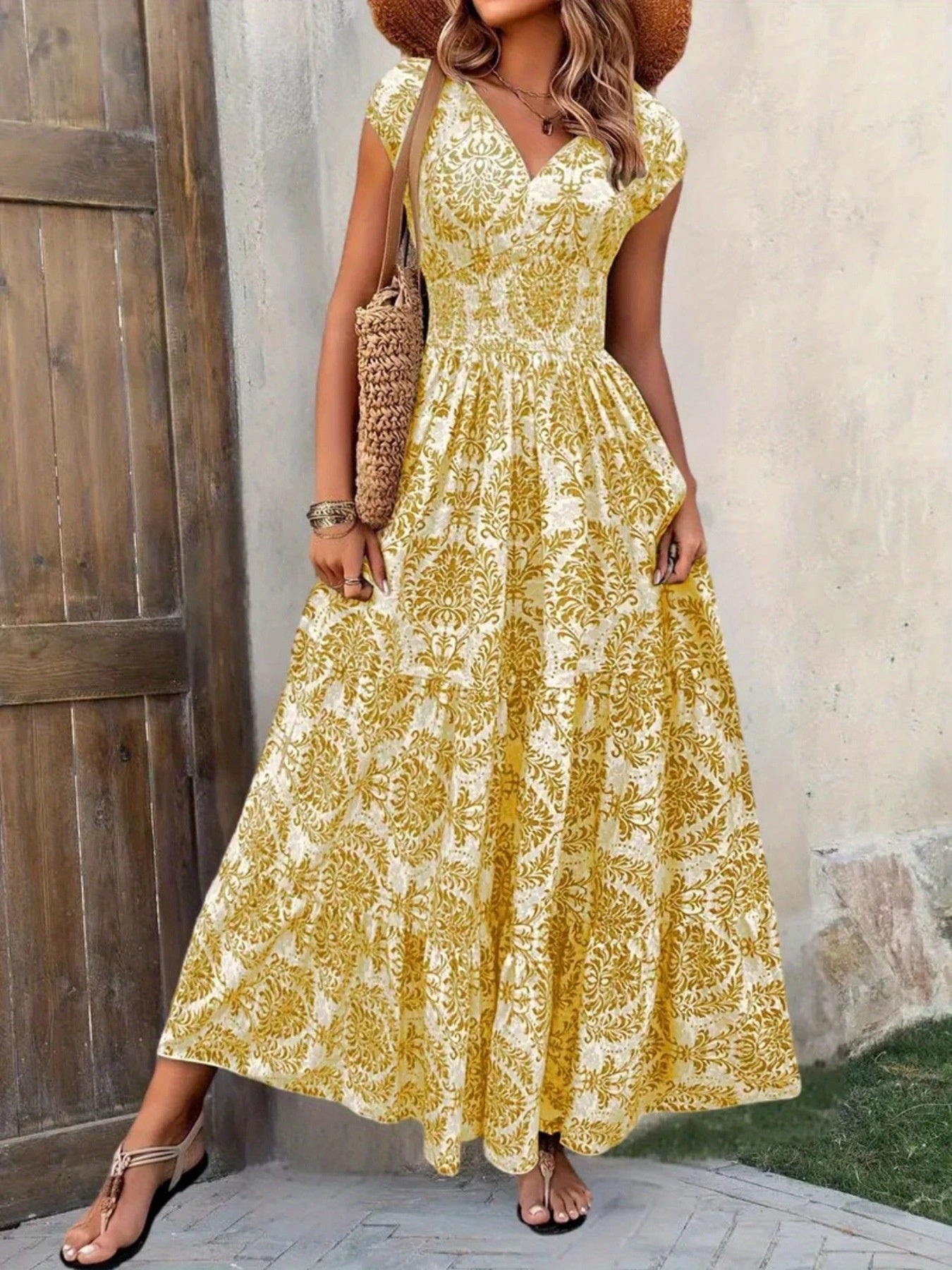 Yellow damask print maxi dress with cap sleeves and tiered skirt.