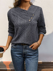 Dark gray cable knit sweater with asymmetric button neck and long sleeves.