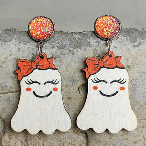 Spooky ghost dangle earrings with orange bows and glitter studs.