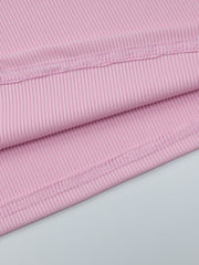 Buttoned ribbed long sleeve top in dusty pink with visible stitching detail.