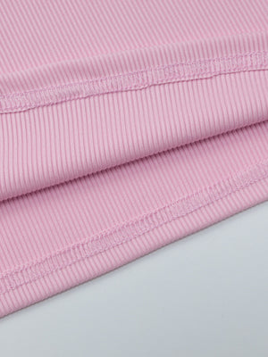 Buttoned ribbed long sleeve top in dusty pink with visible stitching detail.