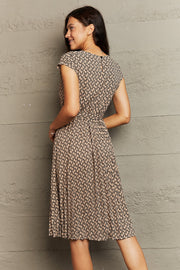 Geometric print midi dress in camel with tie waist and cap sleeves.