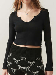 Black ribbed crop top with V-neck and raw hem detail