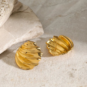 Sculpted spiral gold stud earrings with textured detail.